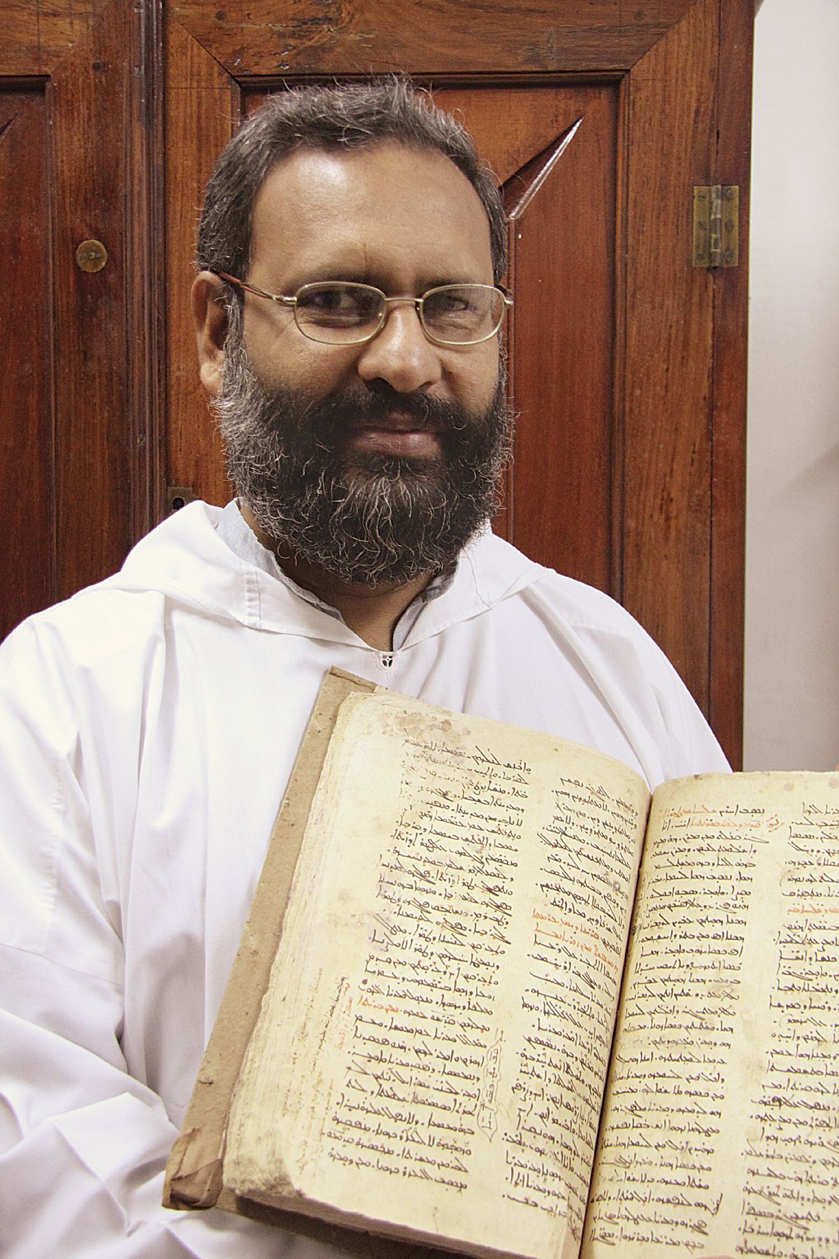 Fr. Johns Abraham Konat, a Malankara Orthodox Syriac priest, holds a family Syriac Bible